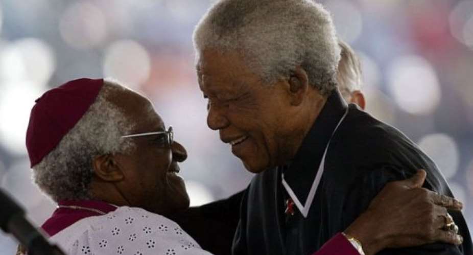 Former South African President Nelson Mandela R huging South African Anglican Bishop Desmond Tutu in 2003.  By Alexander Joe AFPFile
