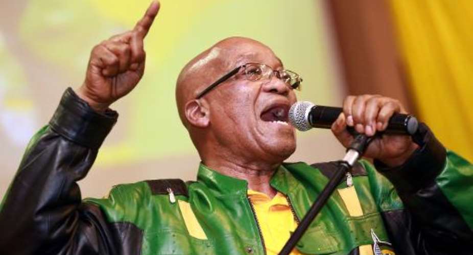 South African President Jacob Zuma leads hundreds of supporters in singing a song during a campaign event in Wentworth township, outside of Durban, on April 9, 2014.  By Rajesh Jantilal AFPFile