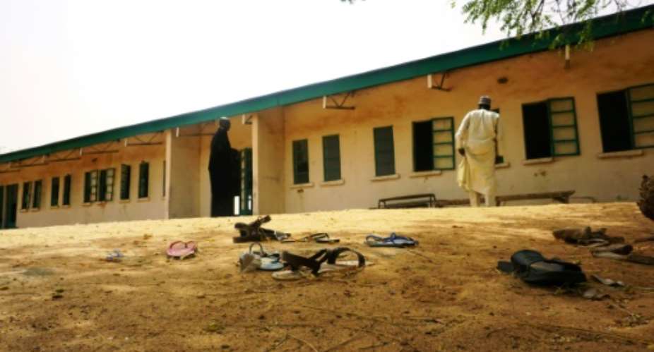 Sandals are strewn in the yard of a school in Dapchi from where Boko Haram jihadists kidnapped 110 schoolgirls in February.  By AMINU ABUBAKAR AFPFile