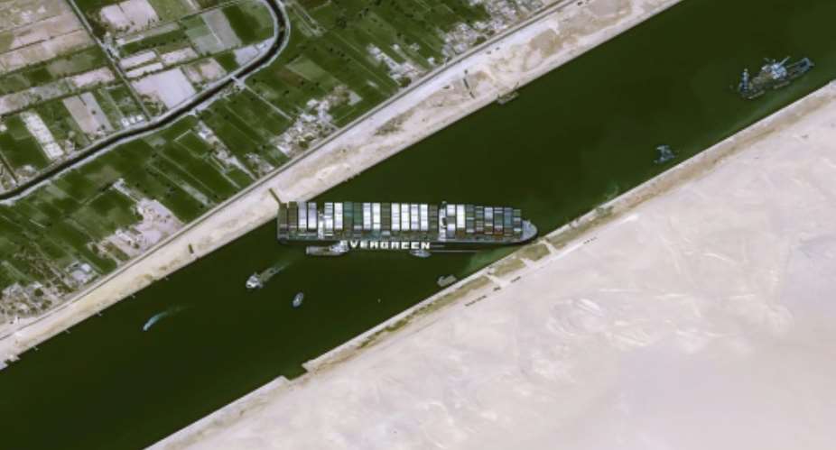 Satellite image shows the Taiwan-owned MV 'Ever Given' Evergreen container ship, a 400-metre- 1,300-foot-long and 59-metre wide vessel, lodged sideways and impeding all traffic across Egypt's Suez Canal.  By - CNESAFP