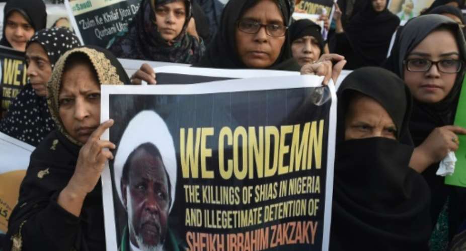 Pakistani Shiite Muslims carry placards of Ibrahim Zakzaky, leader of the Islamic Movement of Nigeria, at a protest against the killing of Shiite Muslims in Pakistan and Nigeria, on December 18, 2015.  By Arif Ali AFPFile