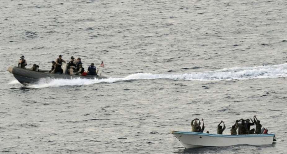 Search and seizure team members L from the USS Vella Gulf close in to apprehend suspected pirates R in the Gulf of Aden in 2009.  By Jason R. Zalasky Navy Visual News ServiceAFPFile
