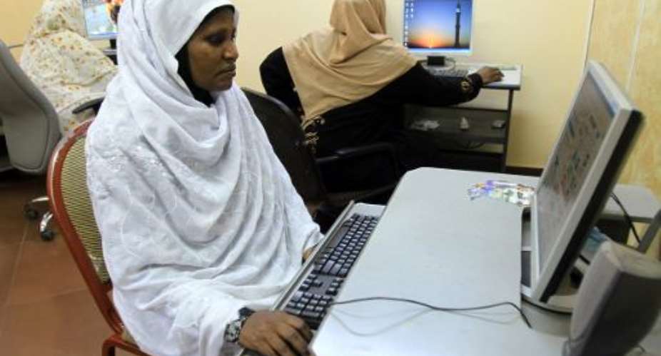 Sudanese women browse the internet at an office in Khartoum on December 14, 2010.  By Ashraf Shazly AFPFile