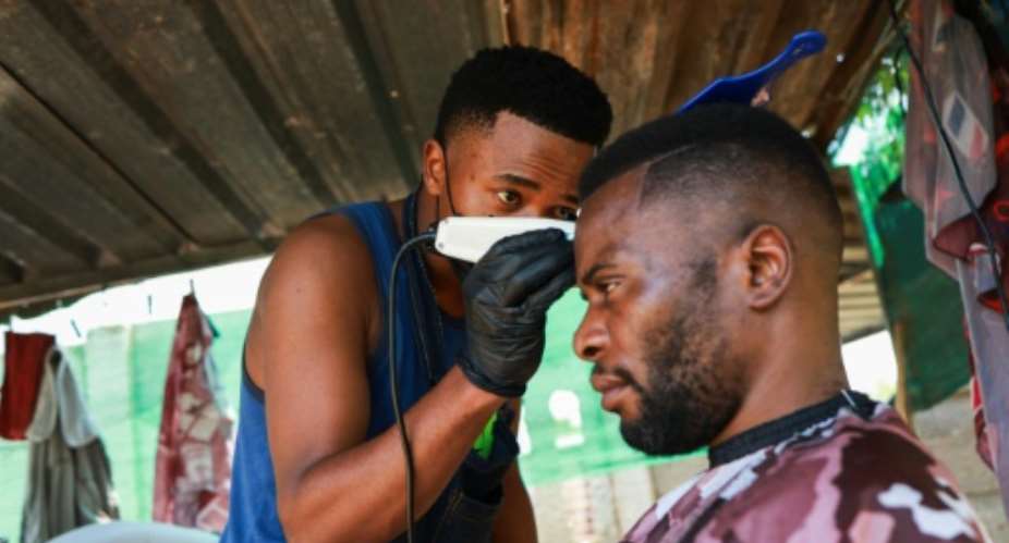 Self-taught barber Thabang Moshoke created his own job when he could not find work in South Africa, whose unemployment rate is one of the highest in the world.  By Phill Magakoe (AFP)