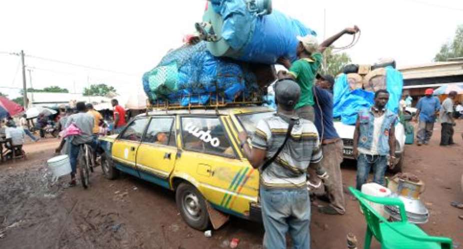 Vehicles are loaded with household items on September 3, 2014, at the border town of Diaobe in Senegal's southern border region of Kolda as they ready to drive across into neighbouring Guinea.  By Seyllou AFPFile