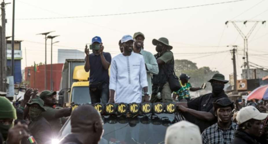 Senegal opposition leader Ousmane Sonko R and his ally and presidential candidate Bassirou Diomaye Faye C campaigned in southern Cap Skirring days after being released from prison.  By MUHAMADOU BITTAYE AFP