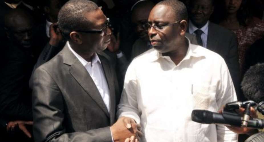 Senegal opposition hopeful Macky Sall R meets singer Youssou Ndour in Dakar.  By Seyllou AFP