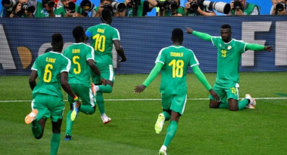 Senegal players go to celebrate with Mbaye Niang after he got what proved to be their winner against Poland.  By Alexander NEMENOV AFP