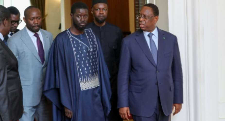 Senegals former presient Macky Sall, right, with the new Prime Minister Ousmane Sonko, centre, and President Bassirou Diomaye Faye, left, after March elections.  By - (Senegalese Presidency/AFP/File)