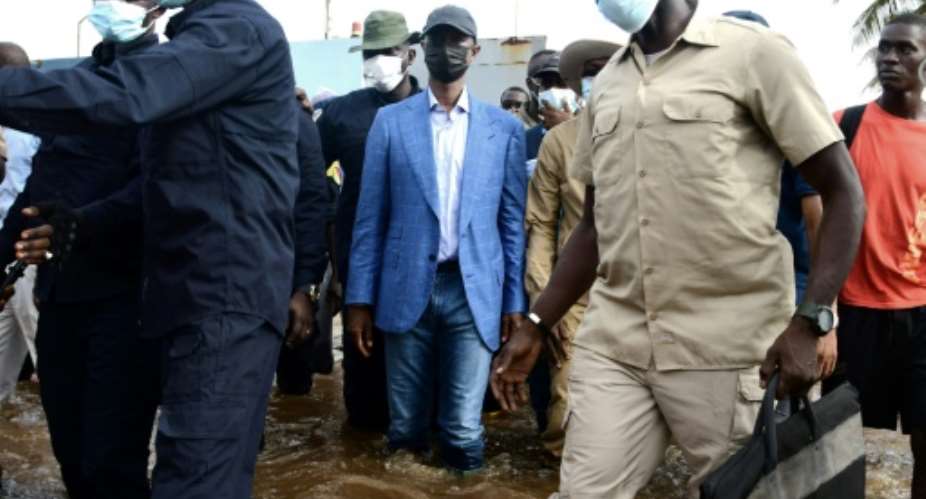 Senegal's Interior Minister, Antoine Felix Abdoulaye Diome, visits flooded areas after heavy rain in Dakar.  By SEYLLOU AFP