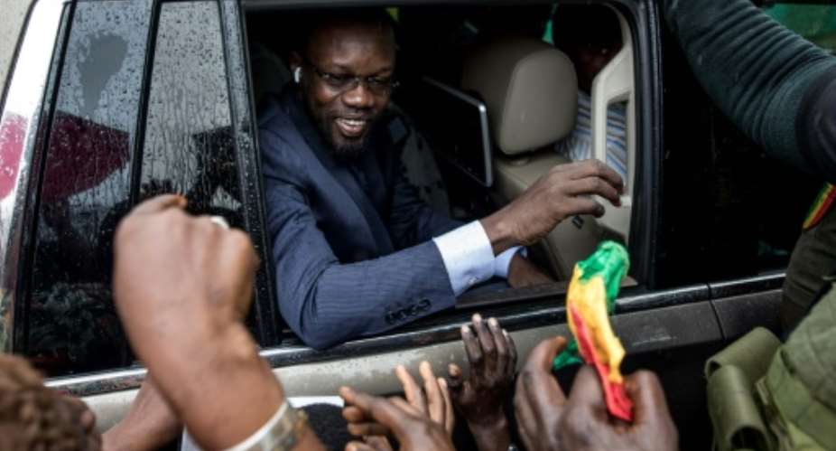 Senegal's opposition figure Ousmane SonkoC says the court cases against him are part of a plot to torpedo his political career.  By MUHAMADOU BITTAYE AFPFile