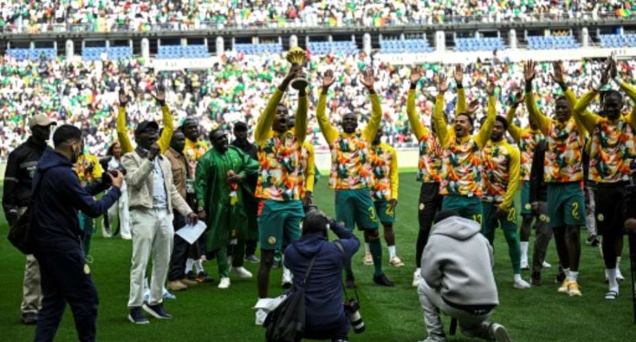 Senegals players performed a lap of honour with the Africa Cup of Nations trophy.  By JULIEN DE ROSA (AFP)