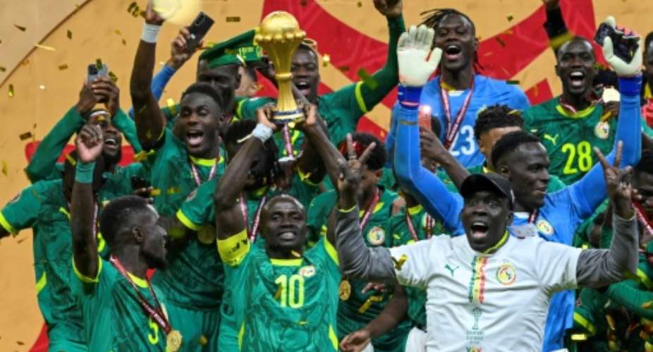 Senegals Sadio Mane, surrounded by teammates, holds the Africa Cup of Nations trophy aloft after his teams 1-0 win over Morocco in the final in Rabat in January.  By SEBASTIEN BOZON (AFP/File)