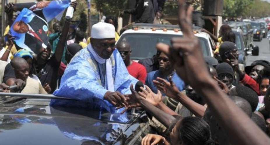 Senegalese President and presidential candidate Abdoulaye Wade greets supporters.  By Issouf Sanogo AFP