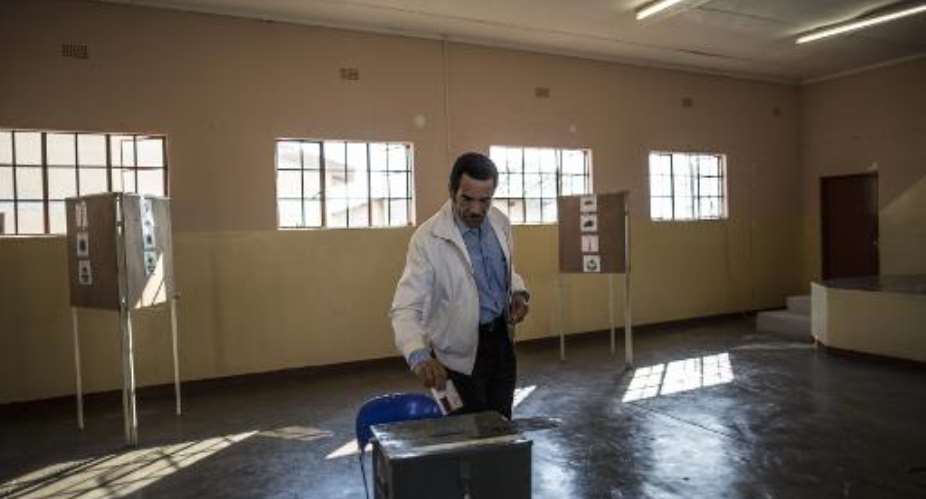 Botswana's President Ian Khama casts his ballot at a polling station in his hometown Serowe on October 24, 2014 for the country's general elections.  By Marco Longari AFP
