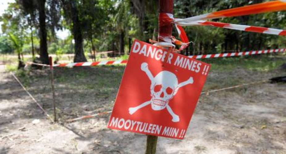 A sign warns locals of a minefield on December 3, 2009, in a village near Kaguit, in the southern Senegalese province of Casamance.  By Seyllou Diallo AFPFile