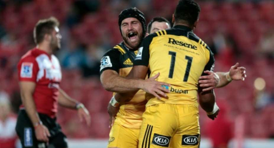Wellington Hurricanes' flanker Callum Gibbins L congratulates wing Julian Savea R after he scored a try during the Super Rugby clash between Lions and Hurricanes on April 30, 2016 in Johannesburg, South Africa.  By Gianluigi Guercia AFP