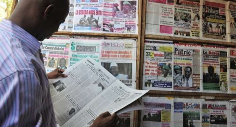 A man reads a local newspaper on April 4, in Bamako.  By Issouf Sanogo AFPFile