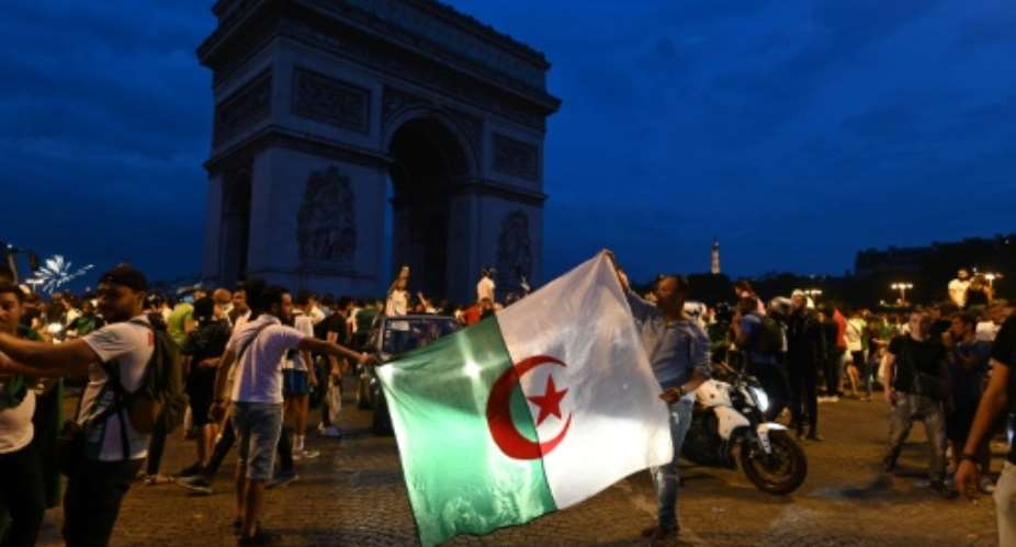 Several thousand people gathered at the Champs-Elysees in the French capital after Algeria's victory against Ivory Coast.  By DOMINIQUE FAGET AFP