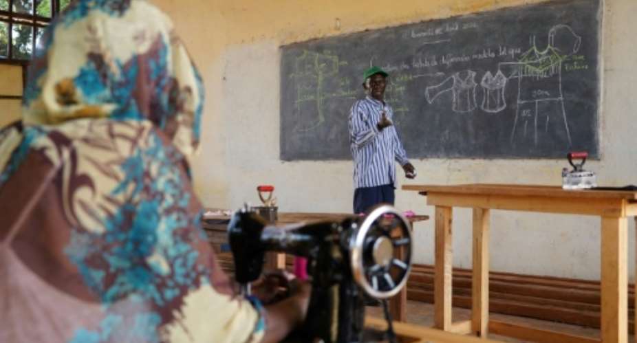 Sewing instructor Yonaba understands the trauma that still haunts his ex-child soldiers pupils.  By Mariam KONE (AFP)