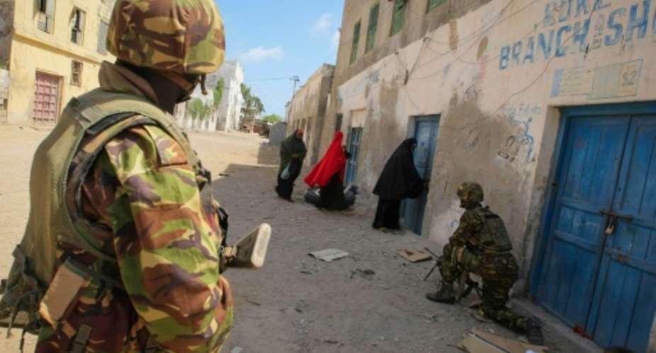 Soldiers of the Kenyan Contingent serving with the African Union Mission in Somalia AMISOM stand guard on a street in the centre of the southern Somali port city of Kismayo on October 5, 2012.  By Stuart Price AU-UN ISTAFPFile
