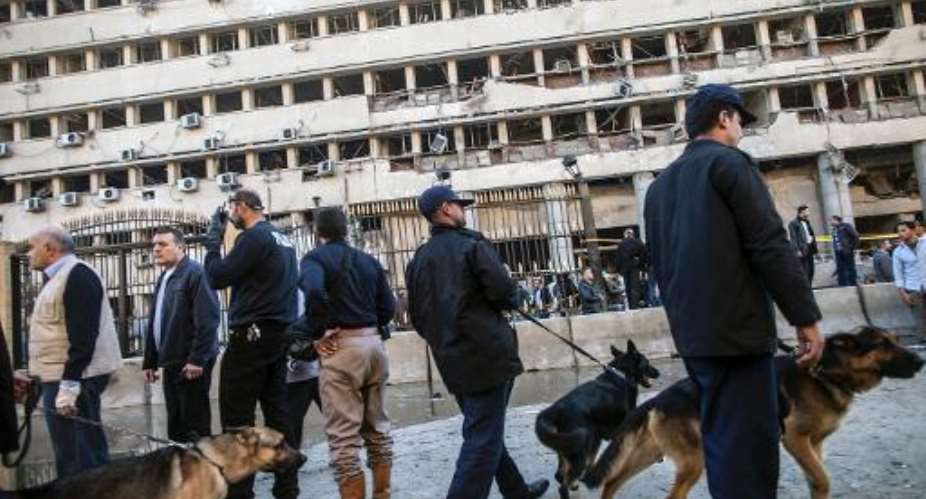 Police guard the scene of a car bomb explosion outside the Cairo police headquarters, on January 24, 2014.  By Mahmoud Khaled AFPFile