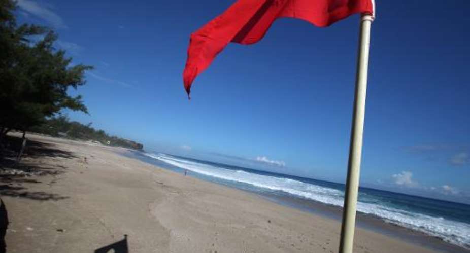 A red flag forbidding swimming because of a shark alert pictured on the beach in Saint-Gilles de la Reunion on the French Indian Ocean island of La Reunion on June 16, 2011.  By Richard Bouhet AFPFile