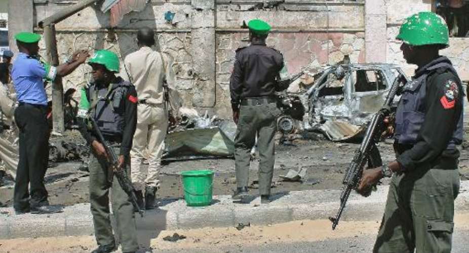 African Union Mission in Somalia AMISOM troops patrol following a blast close to the heavily fortified gates of the airport in Mogadishu on December 3, 2014.  By Abdulfitah Hashi Nor AFPFile