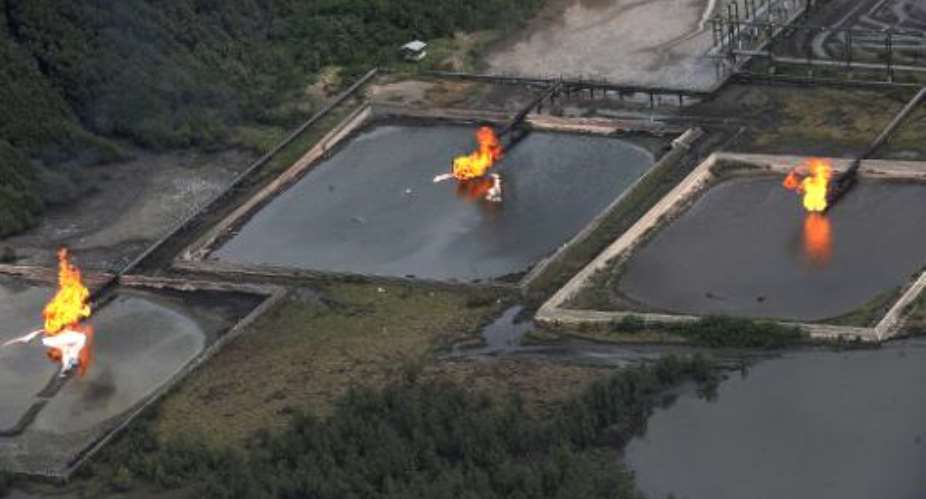 A picture taken on March 22, 2013 shows gas flare at Shell Cawtharine Channel, Nembe Creek in the Niger Delta.  By Pius Utomi Ekpei AFPFile