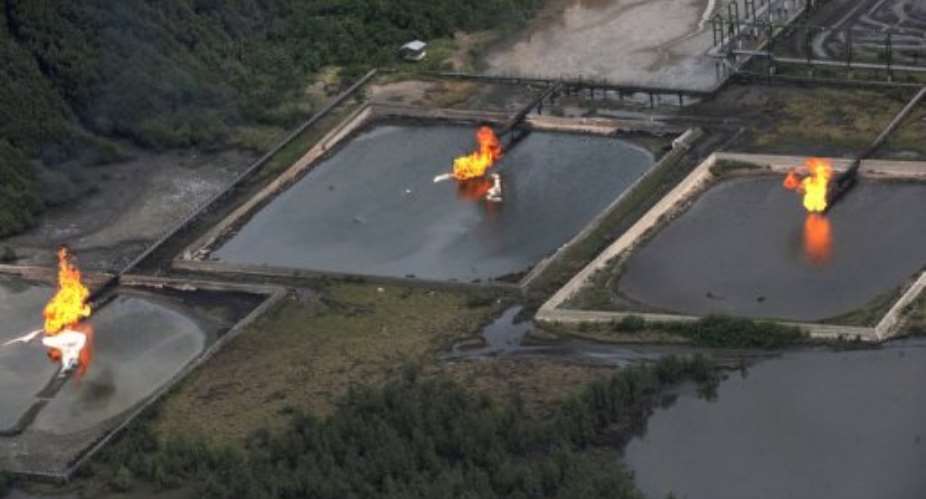 A picture taken on March 22, 2013 shows gas flares at Shell Cawtharine Channel, Nembe Creek in the Niger Delta.  By Pius Utomi Ekpei AFPFile