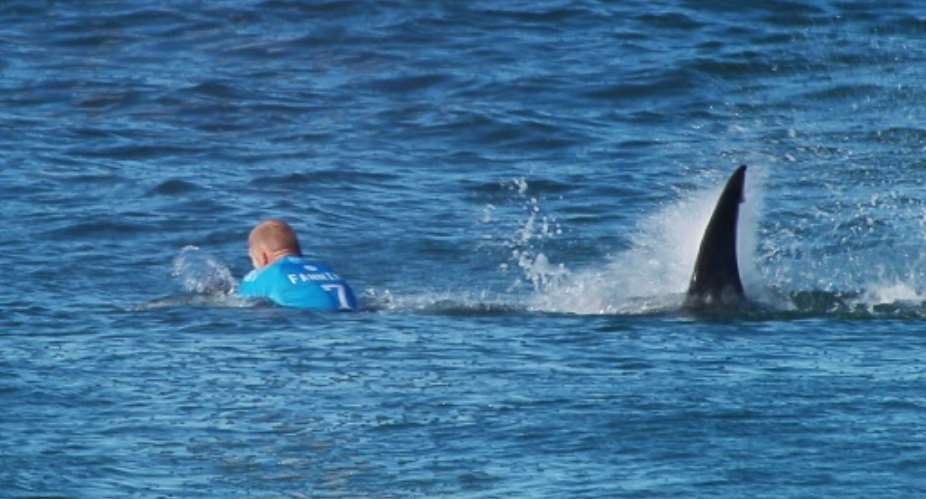 A World Surf League photo shows Australian surfer Mick Fanning being attacked by a shark during the Final of the Surf Open in Jeffreys Bay on July 19, 2015.  By  (WSL/AFP)