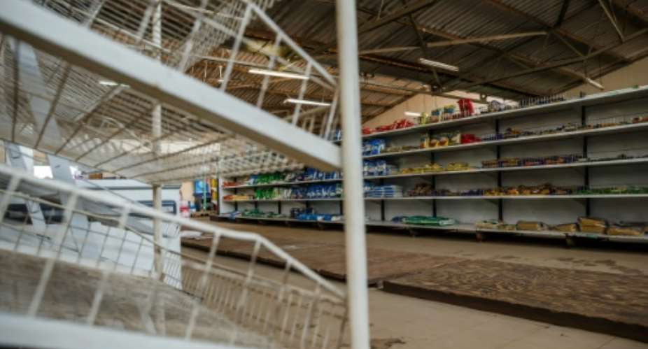 Shops in Zimbabwe are struggling to fill their shelves as the economic crisis worsens.  By Jekesai NJIKIZANA AFP