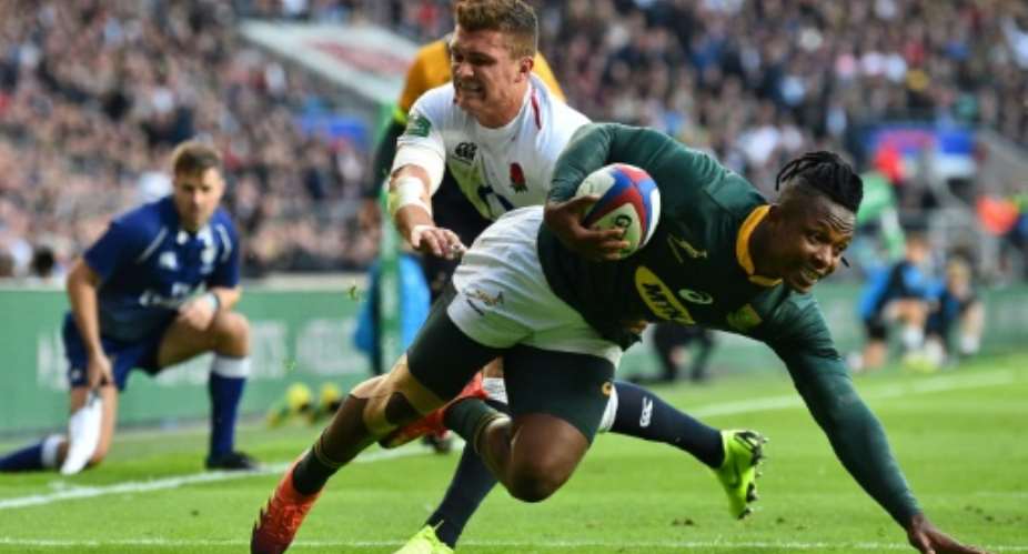 Sibusiso Nkosi R scores for South Africa against England at Twickenham in 2018..  By Glyn KIRK AFP