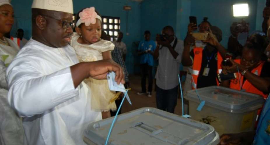 Sierra Leone's opposition Peoples Party presidential candidate Julius Mada Bio, seen here casting his ballot, is ahead by fewer than 15,000 votes.  By Saidu BAH AFPFile