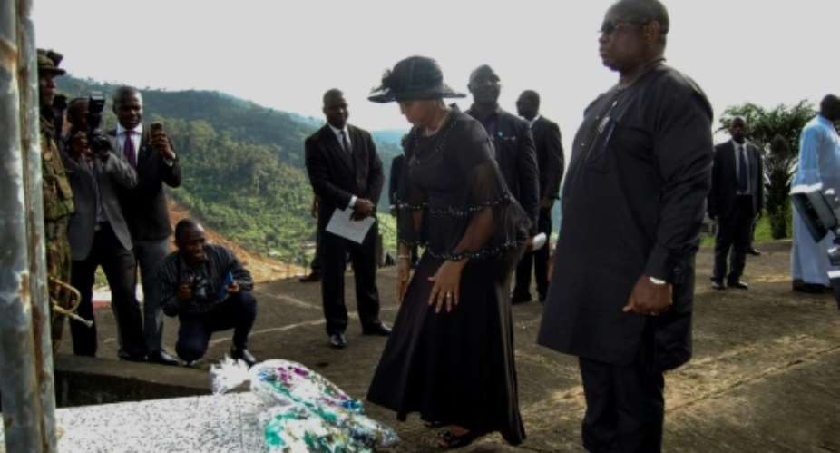Sierra Leone's President Julius Maada Bio R and his wife Fatima Bio lay flowers at the commemoration site for the victims of the 2017 mudslide in Freetown.  By Saidu BAH AFP