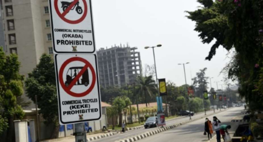 Signs displayed to reinforce a ban on motorbike taxis and motorised rickshaws, known locally as 'okadas' and 'kekes' which has sparked uproar in the Nigerian commercial capital Lagos.  By PIUS UTOMI EKPEI AFP