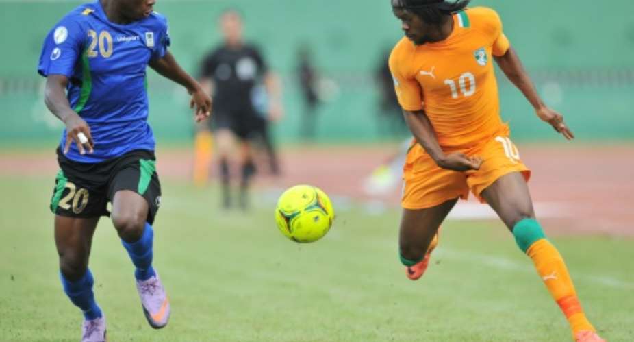 Simba defender Shomari Kapombe (L) contests possession with Gervinho while playing for Tanzania against the Ivory Coast..  By SIA KAMBOU (AFP)
