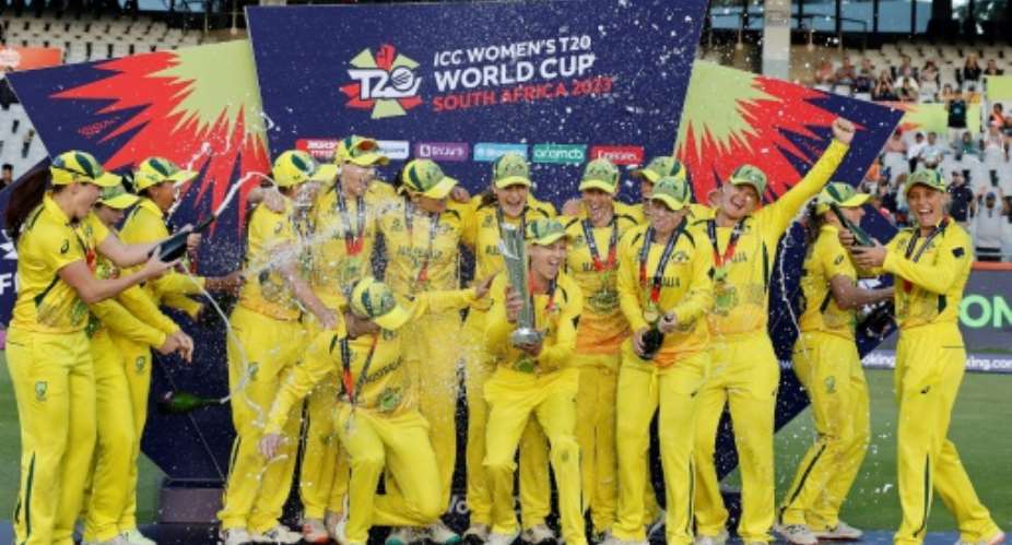Six of the best: Australia captain Meg Lanning holds the trophy and celebrates with her teammates.  By Marco Longari AFP
