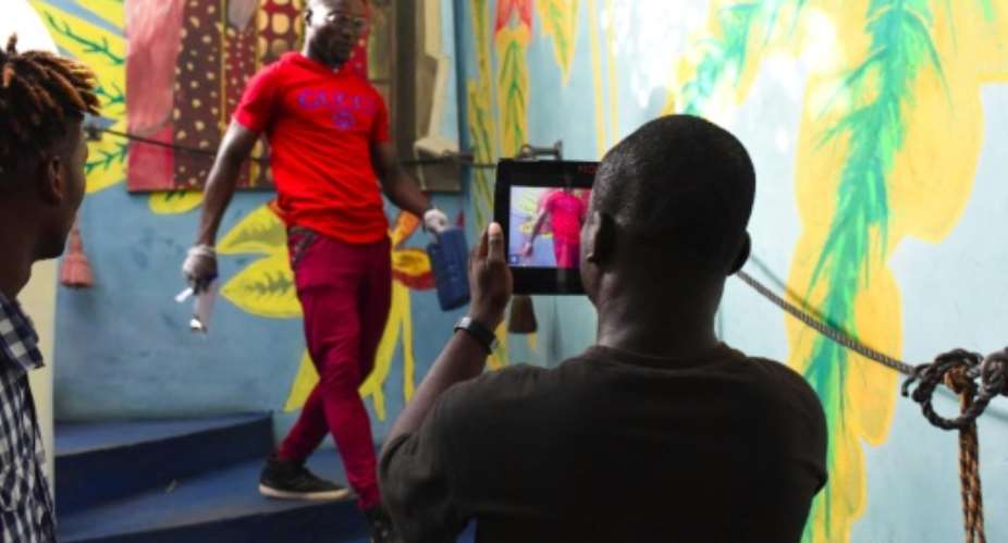 Smartphone filming at a workshop during the Bushman Film Festival at the end of March in Ivory Coast's economic capital Abidjan.  By ISSOUF SANOGO AFPFile