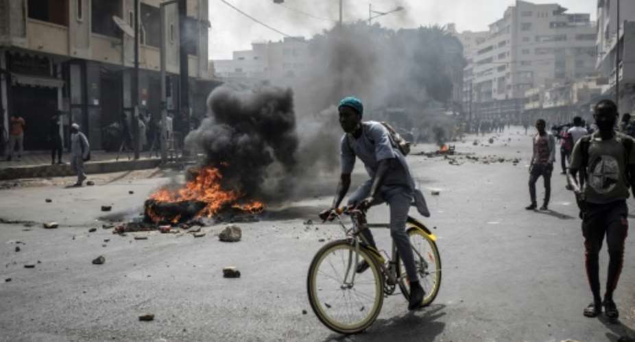 Smoke rose from makeshift barricades in the Senegalese capital.  By JOHN WESSELS AFP