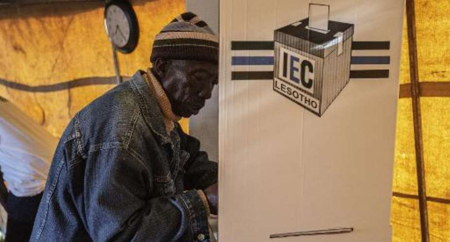 A man prepares his ballot on February 28, 2015 at a polling station outside Maseru, Lesotho.  By Gianluigi Guercia AFP