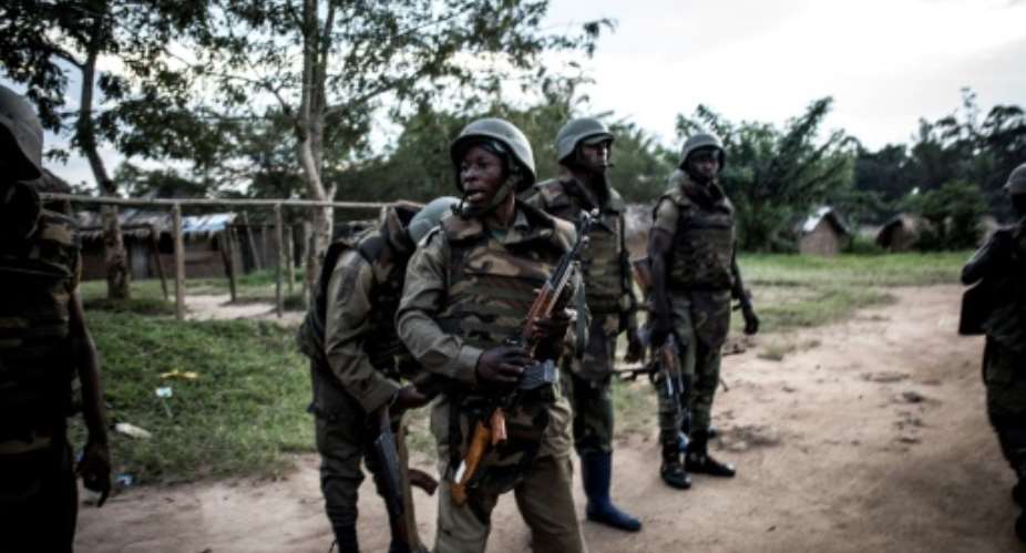 Soldiers from the Armed Forces of the Democratic republic of the Congo FARDC are seen gearing up as gunfire erupts close by on October 7, 2018 outside Oicha.  By JOHN WESSELS AFPFile