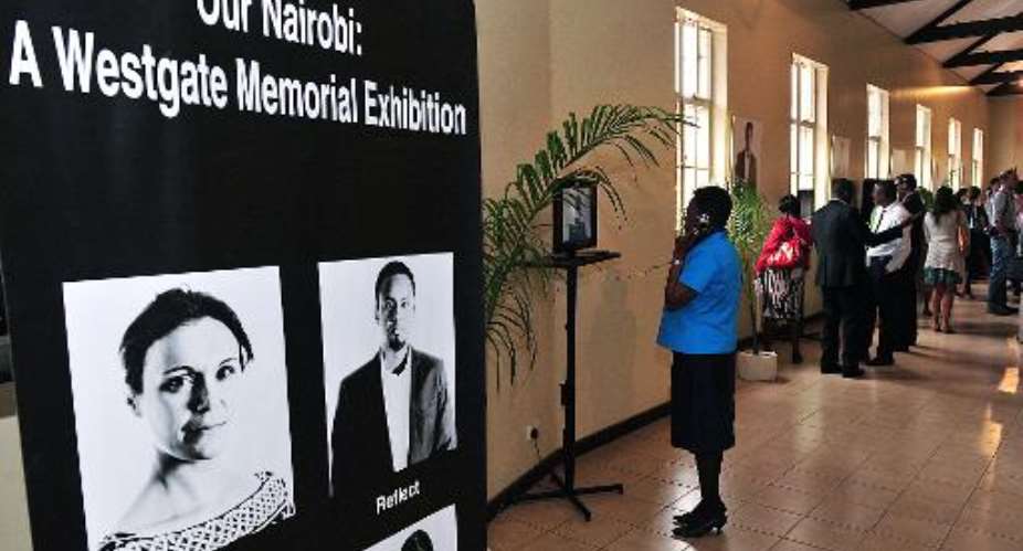 Visitors view an exhibition to mark the one-year anniversary of the Westgate shopping centre siege, on September 16, 2014 in Nairobi.  By Simon Maina AFP