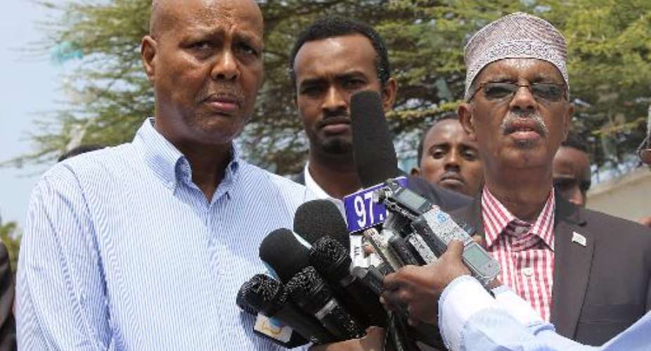 Somali Prime Minister Abduweli Sheikh Ahmed (L) speaks to the press on July 24, 2014 in Mogadishu.  By Abdulfitah Hashi Nor (AFP/File)