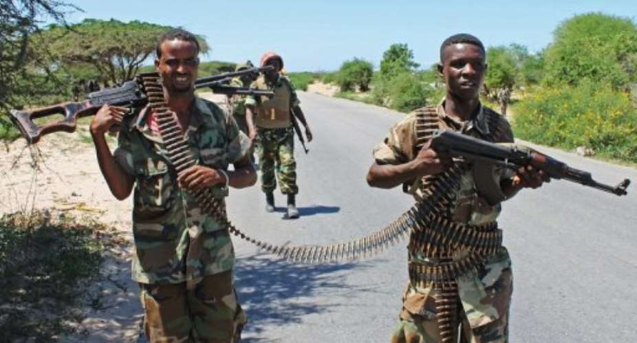 Somali soldiers patrol a stretch of road betwwen Mogadishu and Afgoye.  By Mohamed Abdiwahab (AFP/File)