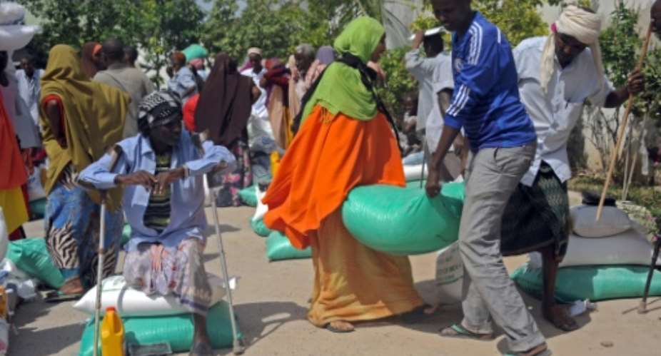 Somali internally displaced people IDPs receive food aid donated by a Qatari charity during the Muslim holy month of Ramadan in Mogadishu on June 20, 2015.  By Mohamed Abdiwahab AFPFile
