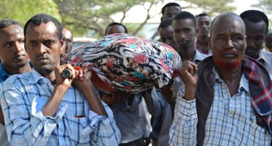 Relatives and fellow journalists carry the body of Somali journalist Mohamed Mohamud Timacade, on October 27, 2013, during his funeral in the capital Mogadishu after he succumbed to bullet injuries at a hospital.  By Mohamed Abdiwahab AFPFile