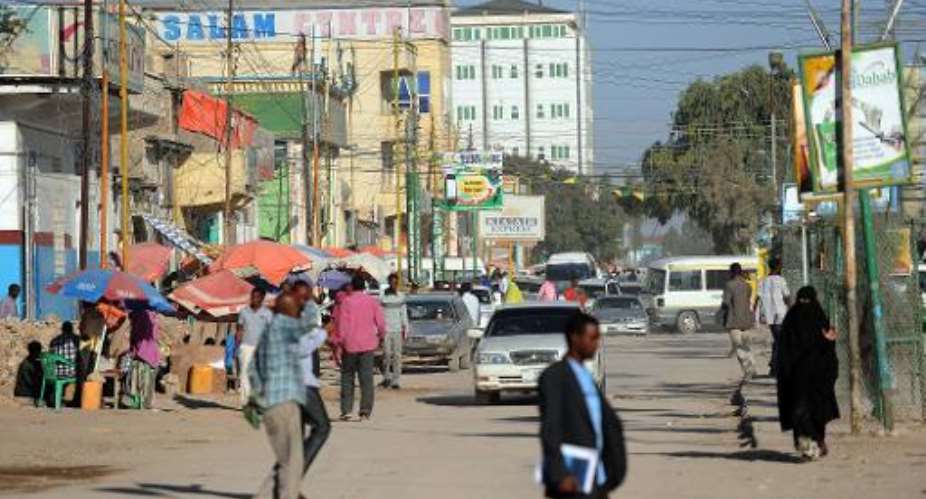 People walk in a street of Somaliland's captal Hargeisa on October 31, 2012.  By Simon Maina AFP