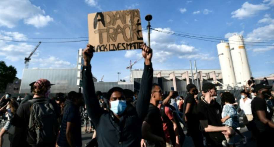 Some 20,000 people protest the 2016 death of a young black man named Adama Traore in French police custody, using slogans echoing those in the demonstrations raging in the US..  By STEPHANE DE SAKUTIN AFP