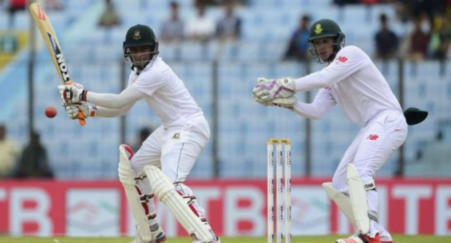 Bangladesh batsman Shakib Al Hasan plays a shot as the South Africa wicketkeeper Quinton de Kock looks on during the third day of the first Test match between Bangladesh and South Africa in Chittagong on July 23, 2015.  By Munir Uz Zaman AFP